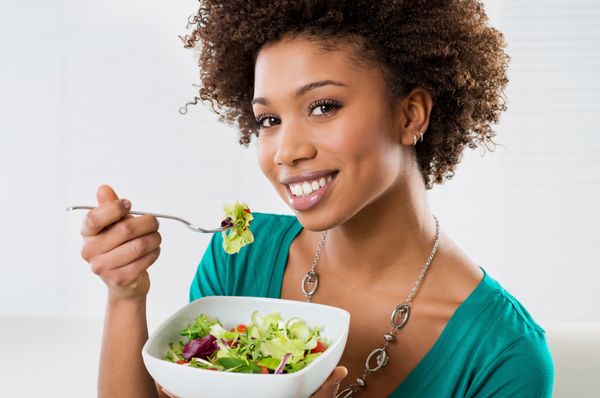 lady smiling eating salad