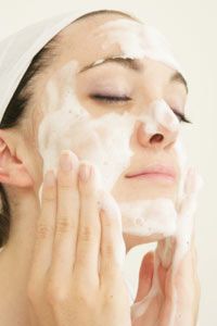 Woman washing face.