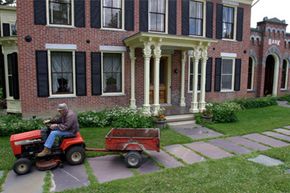 Joe Tomaino heads home on his lawn tractor after conducting his banking business at the First National Bank of Orwell in Orwell, Vt.