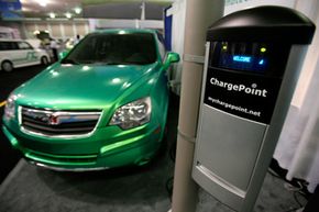 A Saturn Vue plug-in hybrid vehicle is shown with a Smartlet charging station at the Coulomb Technologies exhibit at the Plug-In 2008 conference on plug-in hybrid vehicles in San Jose, Calif.