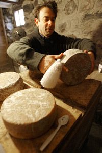 The author Brad Kessler checks his homemade goat cheese in Vermont.