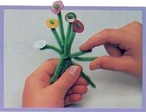 Slip stems through button holes and glue.