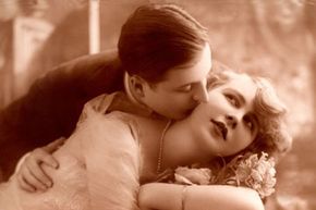 Sepia tone photo of couple in early 20th century garb.