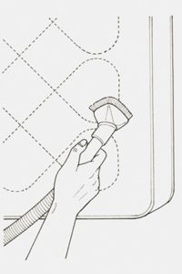 illustration of a person hand vacuuming a mattress