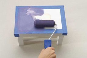 Use a foam roller to paint the top of the stool Purple Dusk.