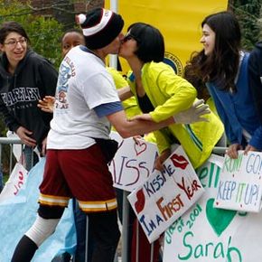 A Wellesley college girl gets a kiss from a runner as the race passes through Wellesley, Mass., during the 114th running of the Boston Marathon.