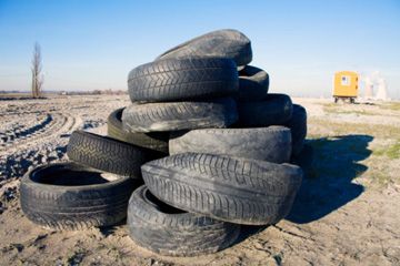 A discarded pile of used tires on a construction yard