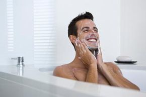 man in tub washes face