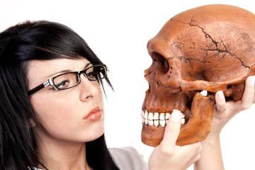 woman looking at a skull