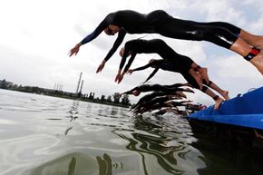 Swimmers dive into the water during the 2010 Dextro Energy Triathlon - ITU Triathlon World Championship Grand Final in Budapest.