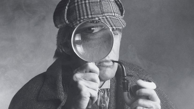 A black and white photograph or detective with a plaid cap, pipe and spyglass