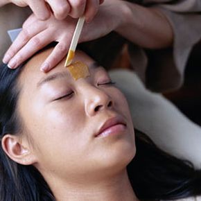 Woman having eyebrows waxed.