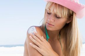 Woman applying sun protection.