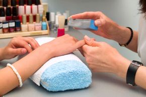 Girl fingernails being manicured.