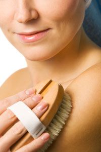 Woman exfoliating arm and shoulder.