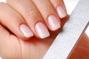 Body-care of hands. Woman polishing nails