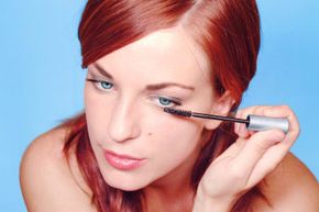 Woman applying mascara.