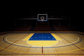 Organizing a basketball tournament means turning this empty court into a packed (and cheering) house.