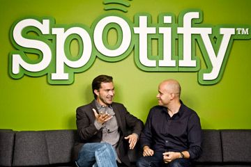 Spotify founders Daniel Ek and Martin Lorentzon in front of green Spotify logo