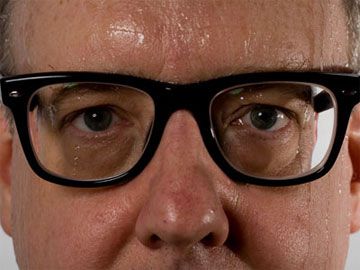 Sweaty man's face with glasses