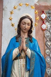 Roman Catholic Italians adorn their homes with religious icons, like this statue of the Virgin Mary on the island of Burano, near Venice.