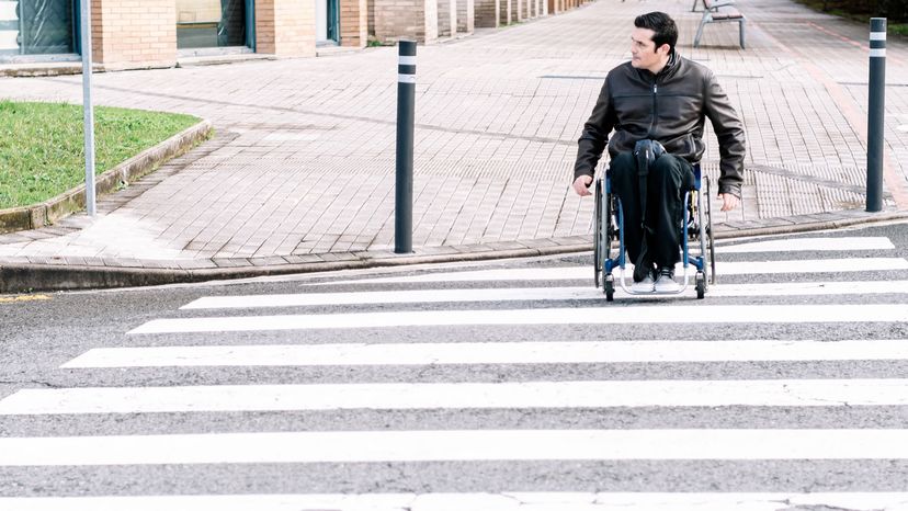 man in wheelchair in street