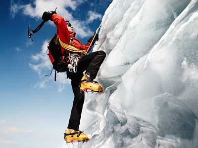 Person adventuring in extreme outdoors sports, mountain climbing.