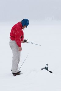 Person enjoying winter sport outdoors in snow.