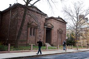 Students walk by the Skull and Bones Society building at Yale University in 2012.