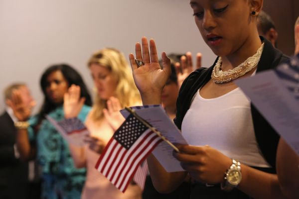 Group of young adults educating women with American flag.