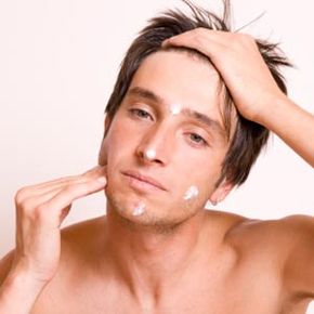 Man moisturizing face.