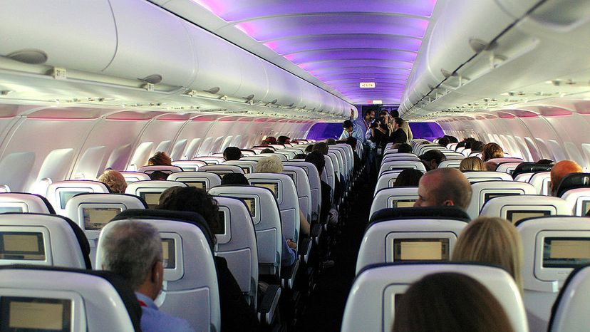 Passengers enjoy Virgin America's in-flight entertainment system, which includes on-demand movies, television, video games, music and onboard chat rooms during a flight from New York to San Francisco. Bob Riha/WireImage/Getty Images