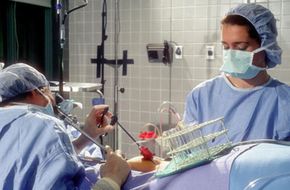 Doctors perform laparoscopice surgery on a woman in preparation for in vitro fertilization.