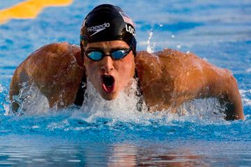 Person swimming in sports race wearing swimming goggles.