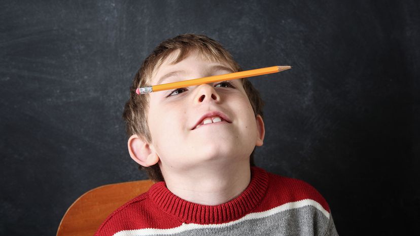 boy with pencil on nose