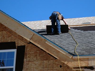 Roofer installing new roof.