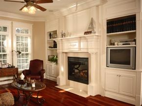 Family room with rich hardwoods and fireplace mantel.