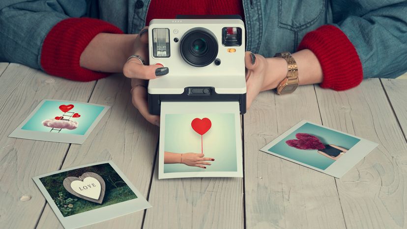 Woman using and instant camera to take pictures