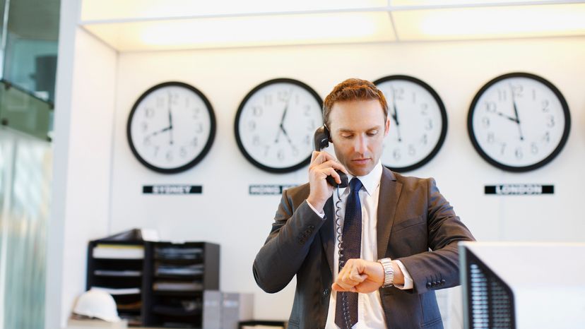 Man Making an International Call in Office