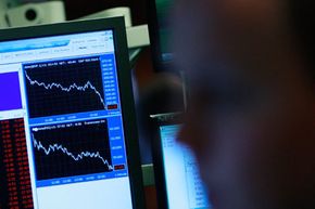 Traders watch as the Dow Jones Industrial Average tumbles on Dec. 1, 2008. 