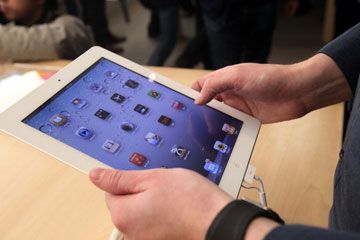 Hands holding Apple iPad 2