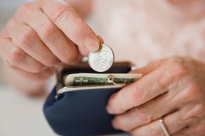 Senior woman holding purse open