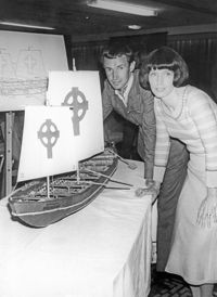 Explorer Tim Severin and his wife Dorothy beside a model of the kind of boat that a 6th century Irish monk could have used to sail to America.