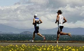Cameron Brown from New Zealand leads Ainalar Juhanson from Estonia during the running leg of the Ironman New Zealand held at Lake Taupo.