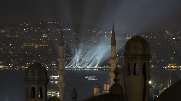 Famous cityscape with minaret at night.