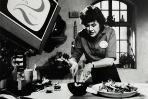 A 1960s-era photo of Julia Child taping an episode of her TV show in her home kitchen.