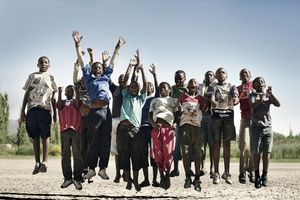 Group of young children jumping in unison