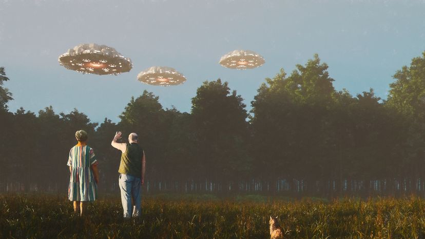 A senior couple waving at UFOs. 