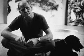 Pollock sits with a dog at his Springs studio in New York in 1953.