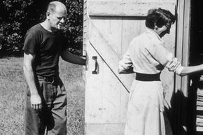 Pollock and his wife Lee Krasner enter the barn door of their Springs studio.